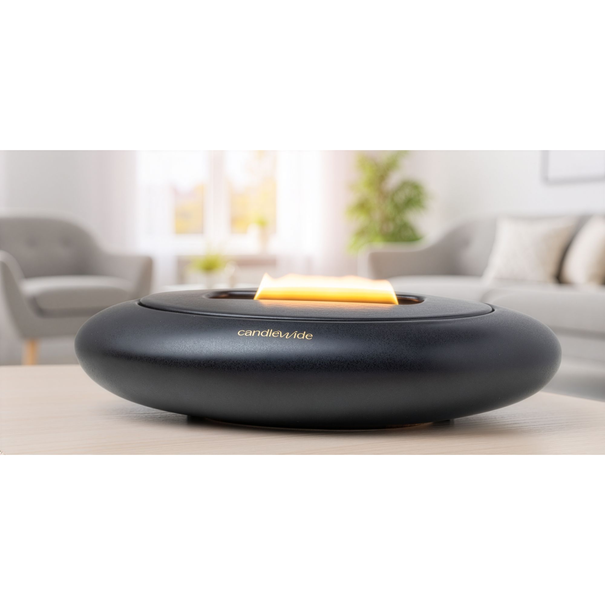 Candlewide Onyx Black refillable ceramic candle burning with a calm wide flame in a living space