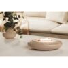 Candlewide Umber Beige refillable ceramic candle burning with a calm wide flame in a living space