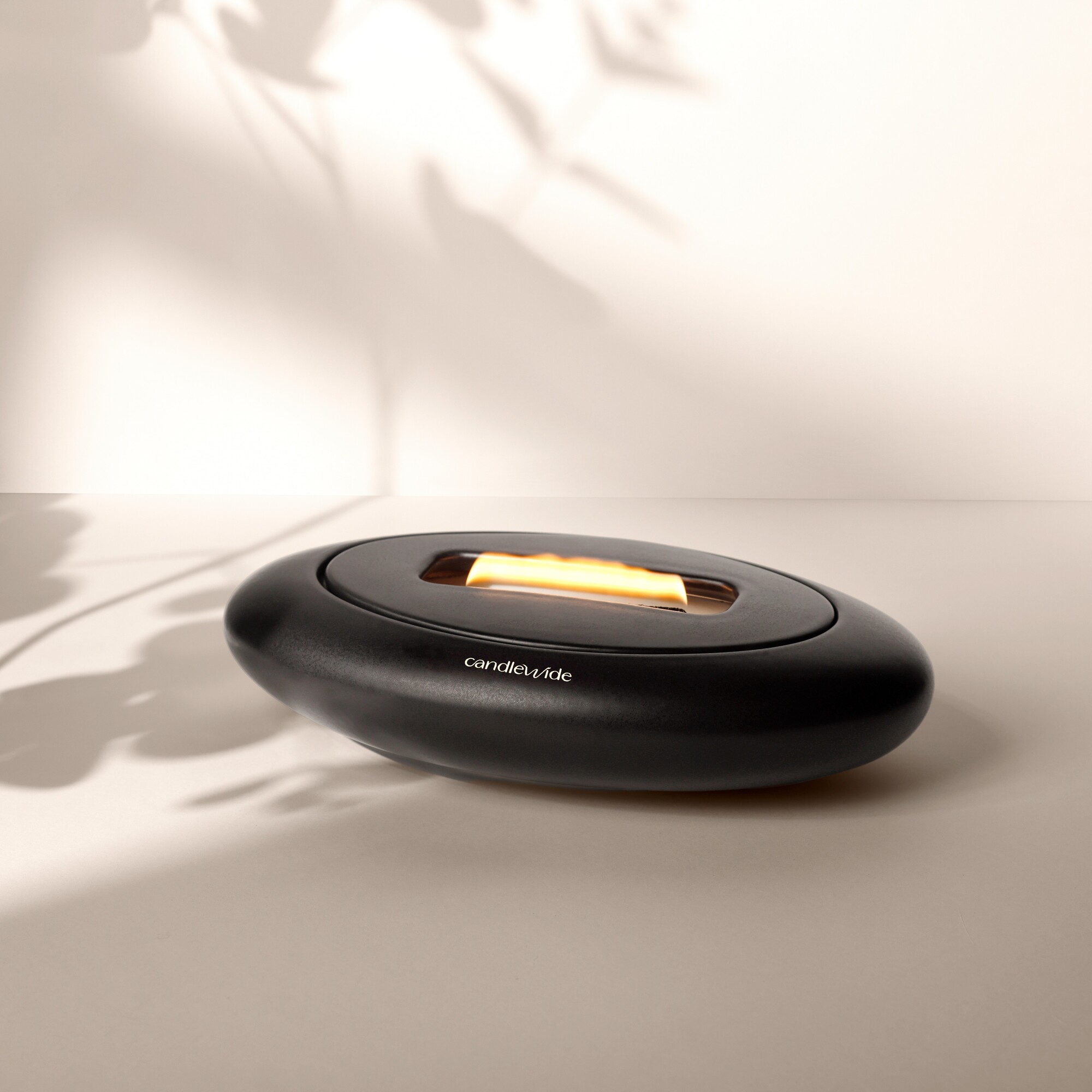 Candlewide Onyx Black refillable ceramic candle with a wide living flame